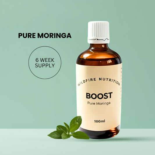 Bottle of Boost Pure Moringa supplement with a green Moringa leaf on a light green background
